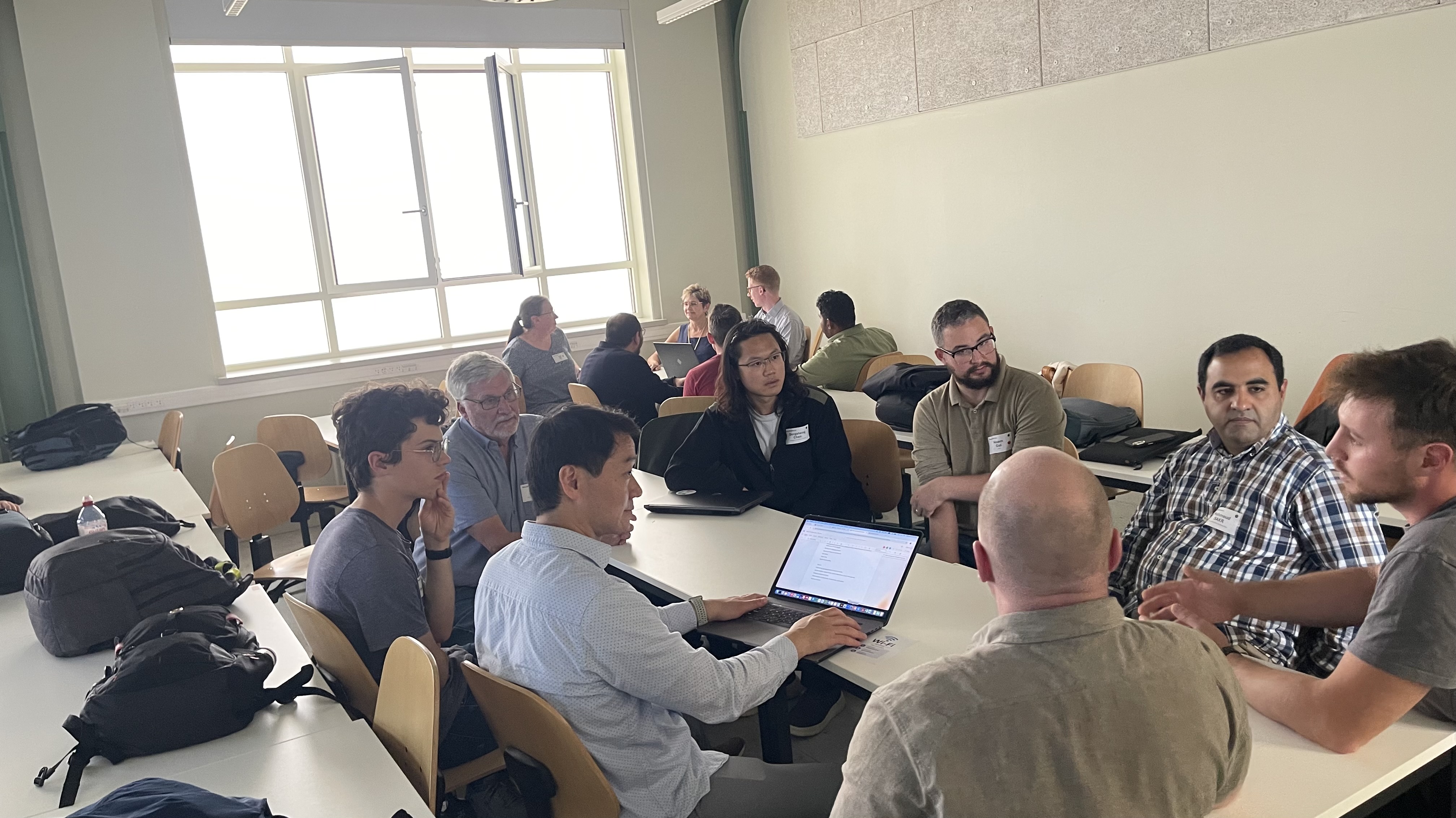 Workshop participants discussing GeoAI learning activities around a table