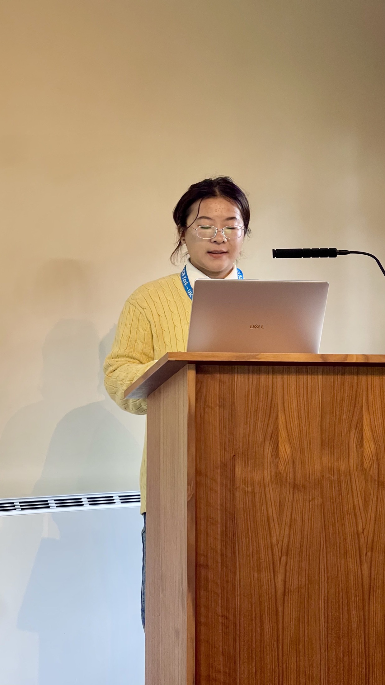 Fengjiao at the podium during her COSIT 2026 presentation