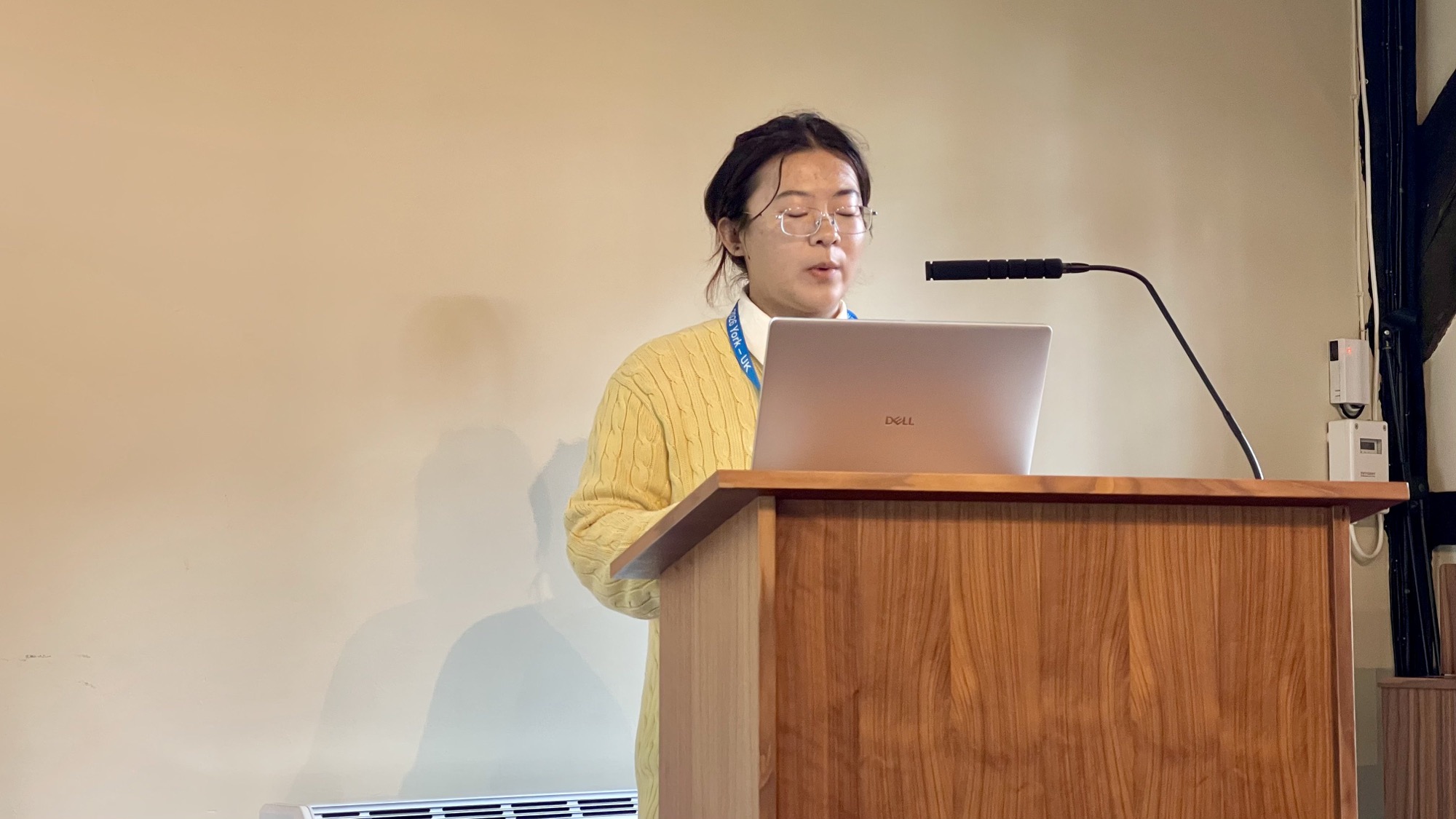 Fengjiao speaking at the COSIT 2026 podium